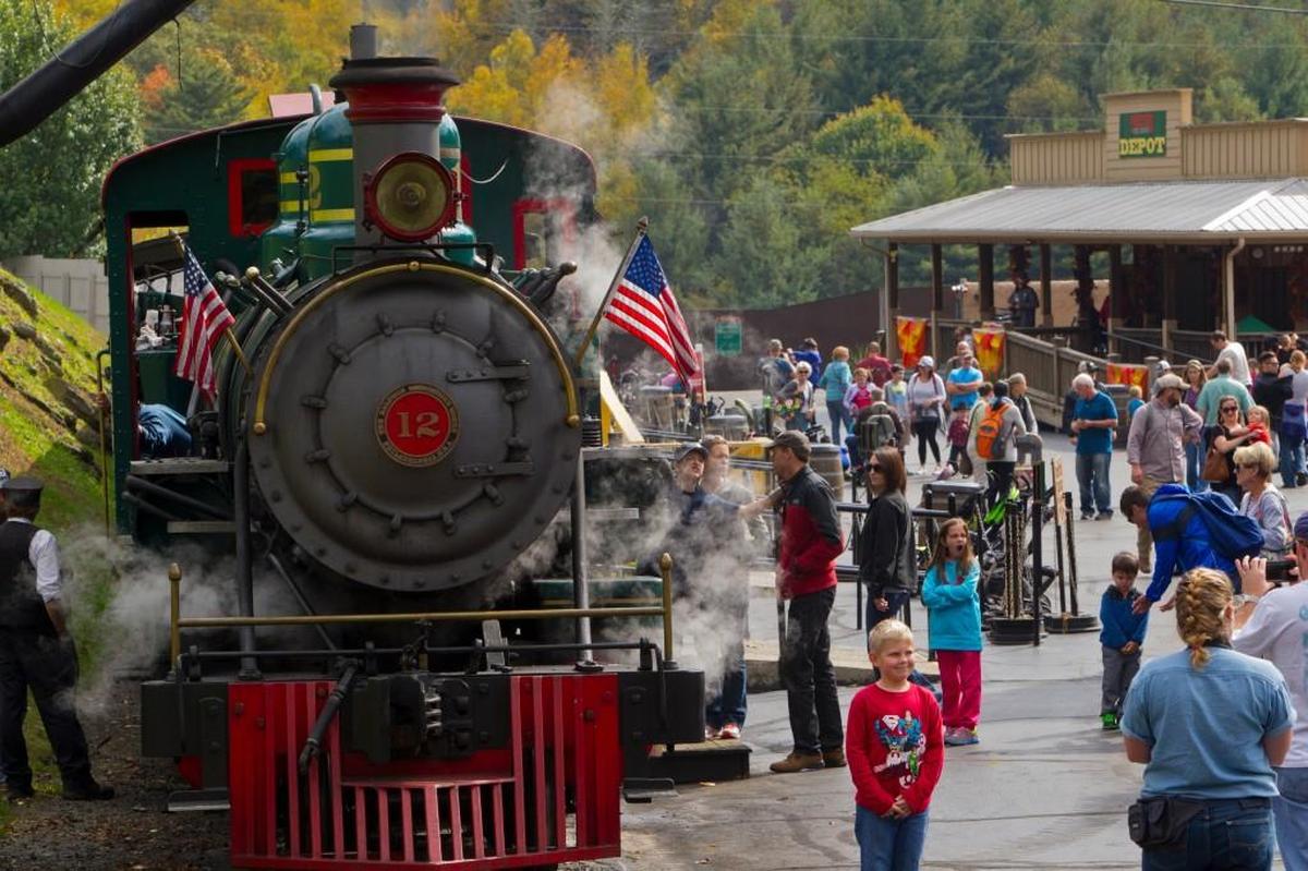 Guests walk past the Number 12 steam engine at the Tweetsie Railroad. The North Carolina attraction opened in 1957 with a one-mile ride aboard the No. 12, the only surviving narrow-gauge engine from the East Tennessee and Western North Carolina Railroad.