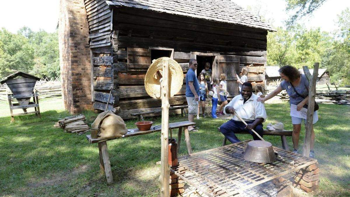 Visitors at Historic Brattonsville last year tour a slave cabin at the “By the Sweat of Our Brows” event.