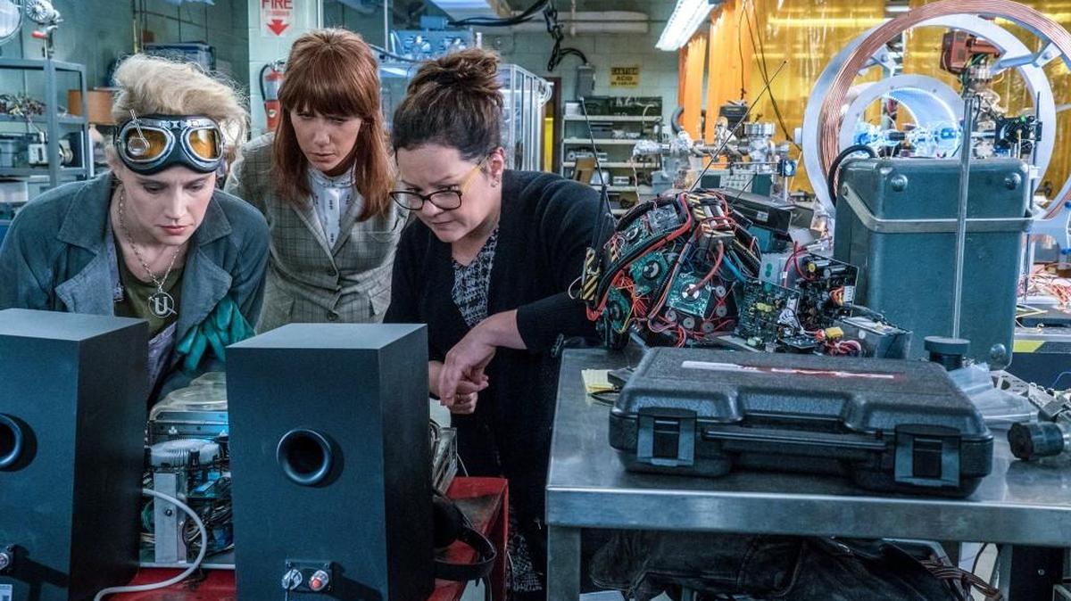 Erin (Kristen Wiig) comes to talk to Abby (Melissa McCarthy) and Holtzmann (Kate McKinnon) at the Paranormal Studies Lab at the Higgin’s Institute in “Ghostbusters.” (Hopper Stone)