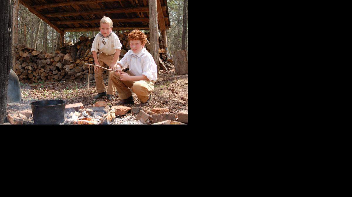 
Two young volunteer interpreters are getting ready for candle-dipping during a recent “Children’s Day on the Farm.”
