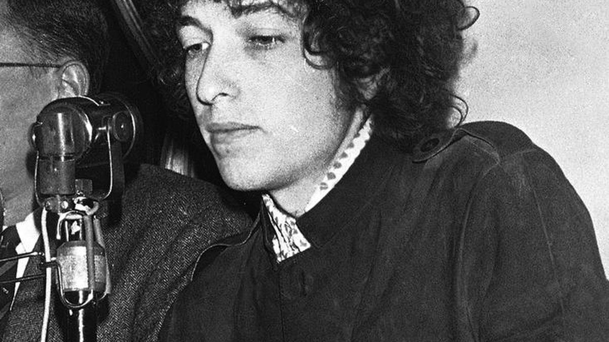 In this May 22, 1966 file photo, Bob Dylan gestures during a press conference in Paris, France. Dylan's tumble from his Triumph in Woodstock, N.Y., 50 years ago on July 29, 1966, was the most analyzed motorcycle crash in pop-culture history. But for all its import, details surrounding the crash remain foggy.