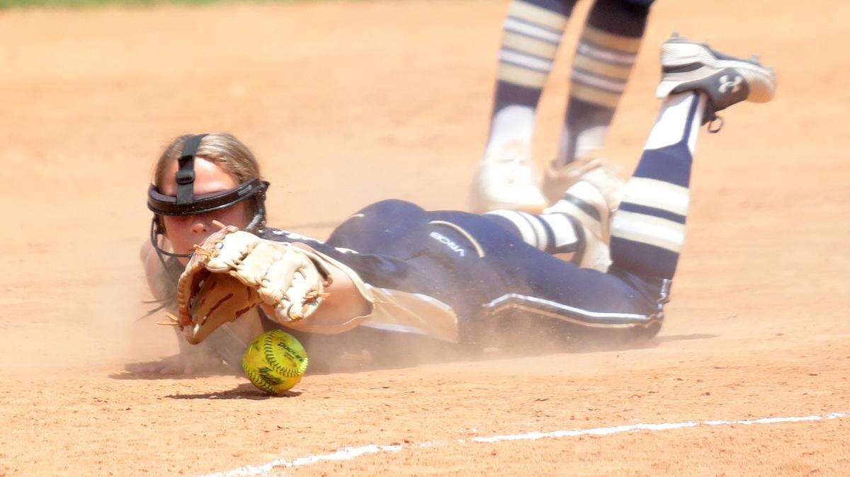 16-year-old Mackenzi Schultz of the Bison Outlaws softball team tries to catch the ball Sunday at the NSA Fastpitch Softball World Series at Cherry Park. The team is from Rockford, Ill.