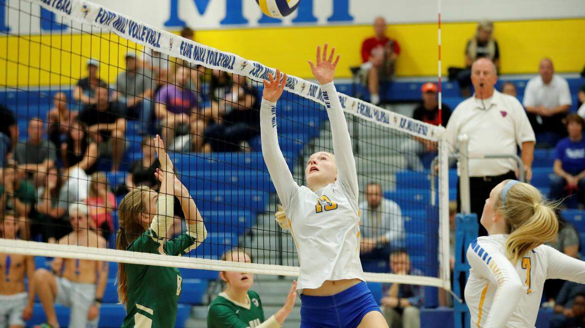 Fort Mill’s #13 Hannah Behrmann dumps the ball over the net as Fort Mill hosts Catawba Ridge in varsity volleyball action.