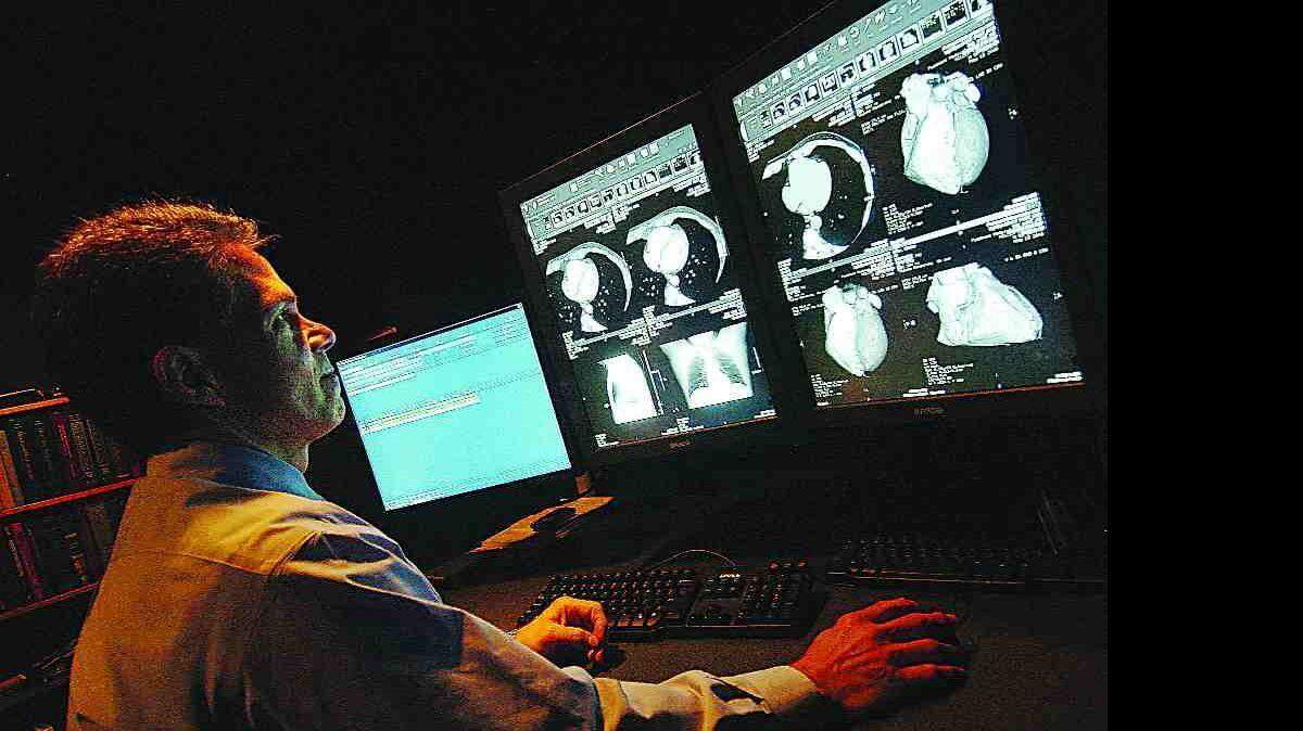 Dr. Ed McKinney, a radiologist, looks at the image of a patient's heart on the Picture Archiving and Communication System at Piedmont Medical Center in Rock Hill. PACS is the biggest investment in technology Piedmont has made in the last year. The average costs at the hospital increased 7 percent last year, but PMC still is among the lowest of 11 hospitals in the region, according to the hospital's annual report.