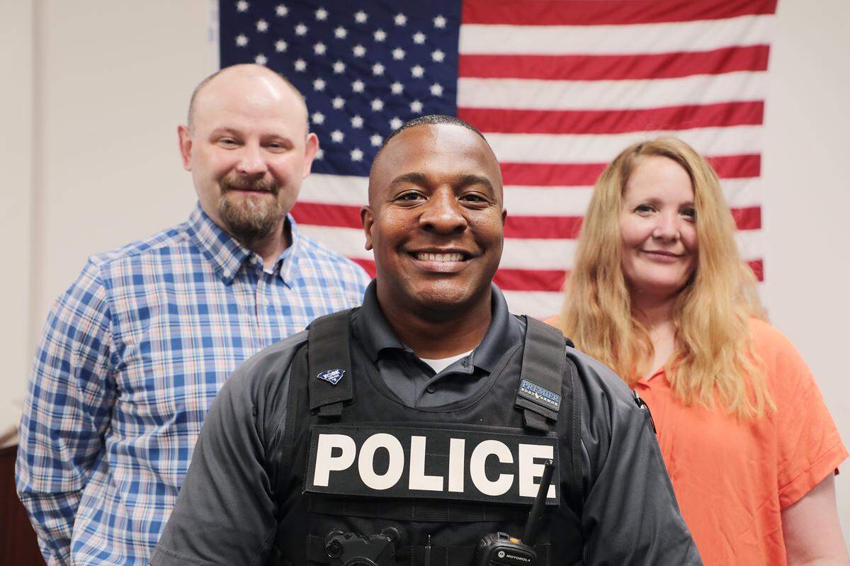 York police officer Pierre King, center, saved the life of Jamie Brock, left, after Brock’s wife Kimberly Brock, right, yelled for help at Longhorn Steakhouse.