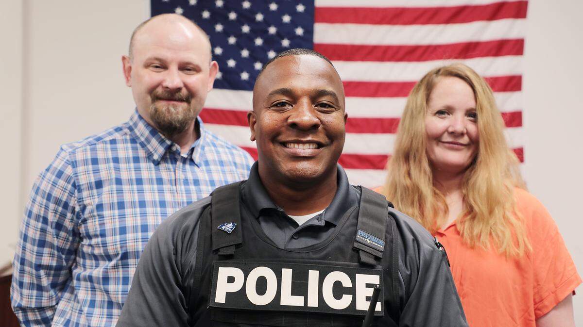 York police officer Pierre King, center, saved the life of Jamie Brock, left, after Brock’s wife Kimberly Brock, right, yelled for help at Longhorn Steakhouse.