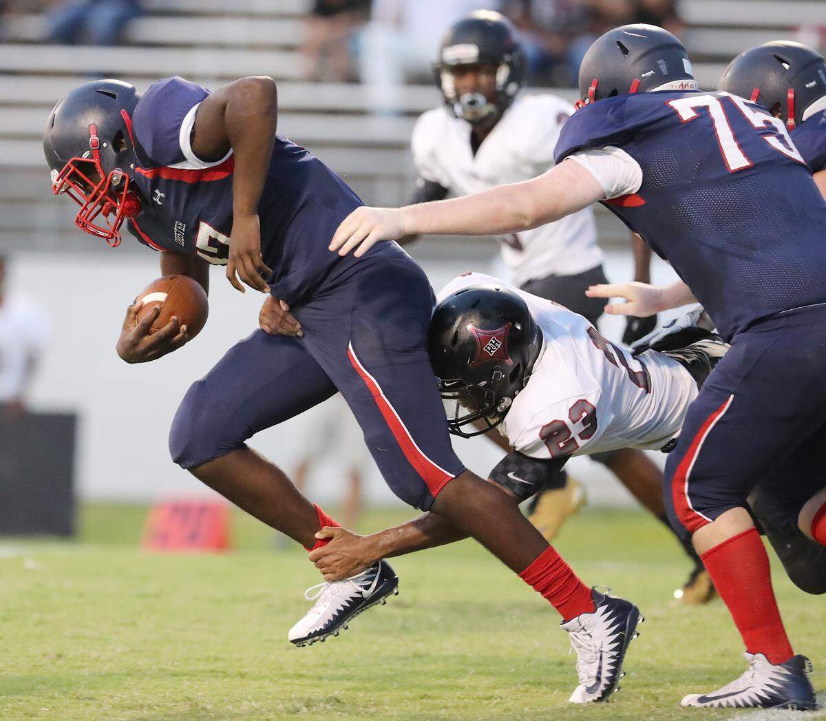 Chester quarterback Zan Dunham picks up yardage before being taken down by Rock Hill’s Nick Ervin on Aug. 31, 2018.
