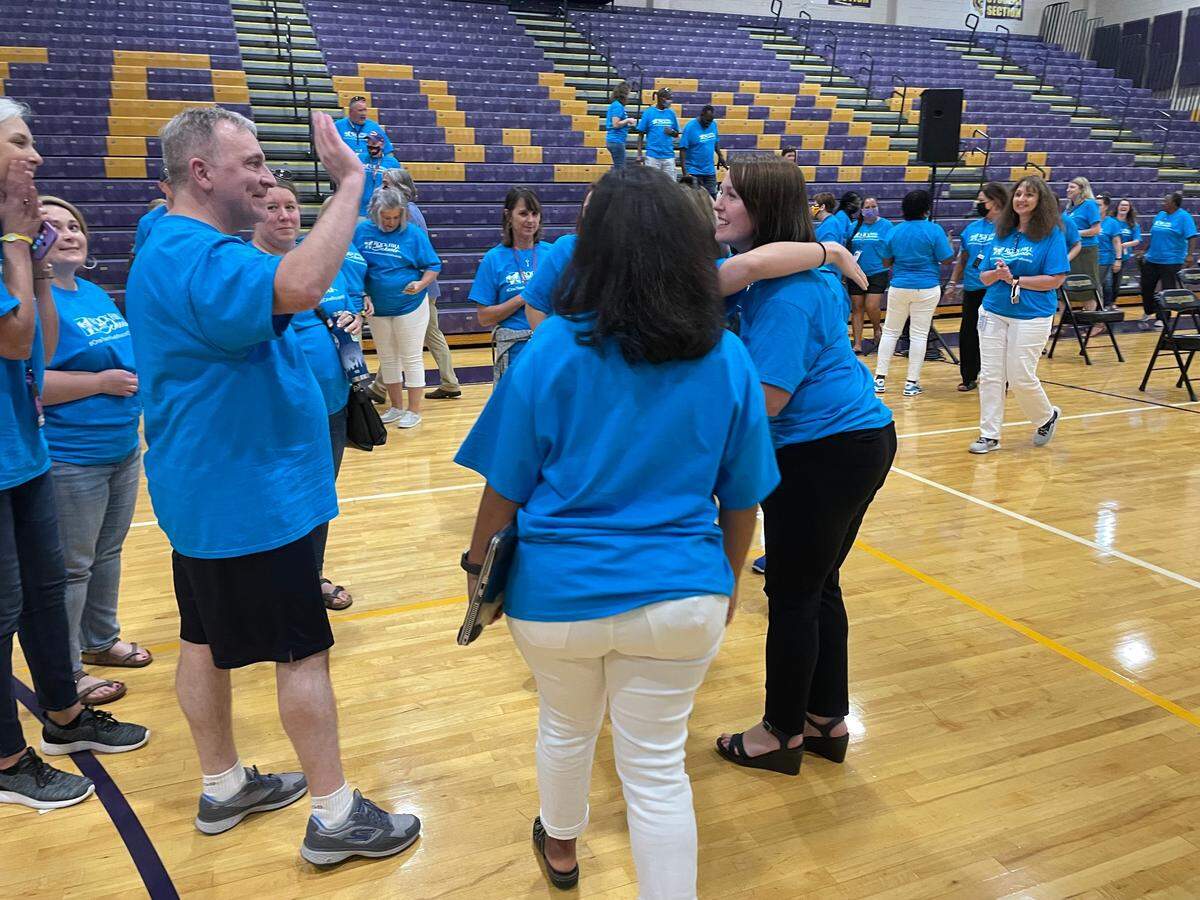 Amy Medina, left, receives hugs and congratulations from fellow Northwestern colleagues on Tuesday in Rock Hill.