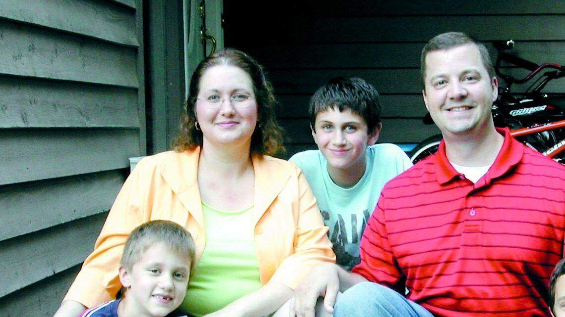The Greek family enjoy a moment on the porch of their temporary Tega Cay home. They are (from left): Zachary, 7, Jesica, William, 11, Nathaniel and Nicholas, 9.