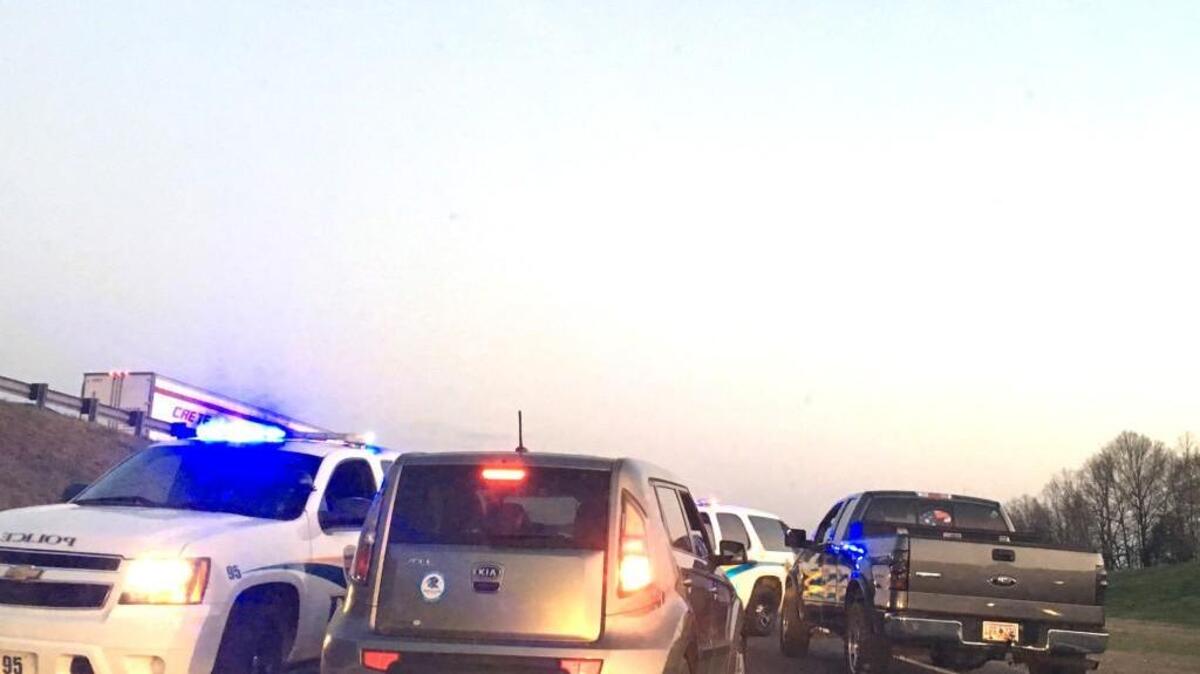 A police vehicle navigates through cars stuck on the I-77 entrance ramp from Cherry Road during rush hour Monday after a tractor trailer overturned, snarling the evening commute.