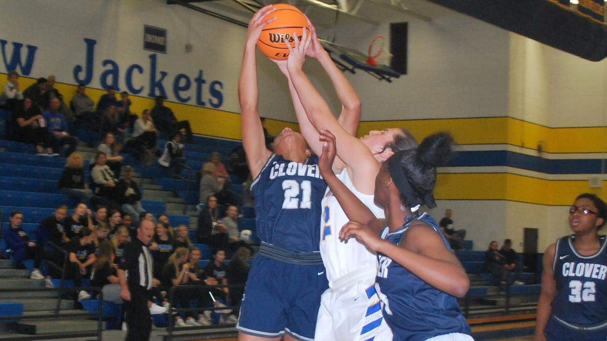 Clover’s Janelle Carter grabs a rebound over Fort Mill’s Abby Snearly during the teams’ contest on Wednesday, Jan. 22.