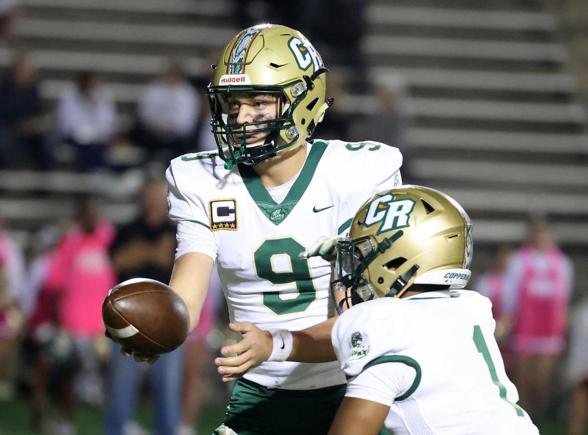 Catawba Ridge’s C.J. Couch hands the ball off to Dev Crawford during an October game.