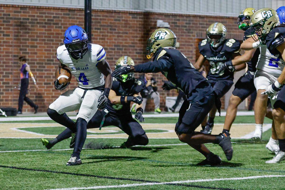 Indian Land's Jamol Horton (4) carries the ball as the undefeated Warriors take on Catawba Ridge earlier this month.