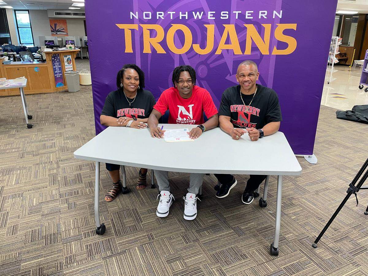 AJ Thompson of Northwestern signed to play basketball at Newberry College with his parents on Wednesday, June 9.