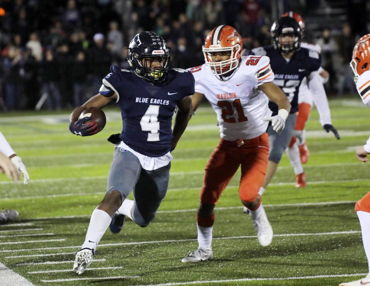Clover’s Zacch Davis carries the ball against Mauldin’s Aj Flood (21) during the first half of the game as the Blue Eagles take on the Mavericks in Clover.