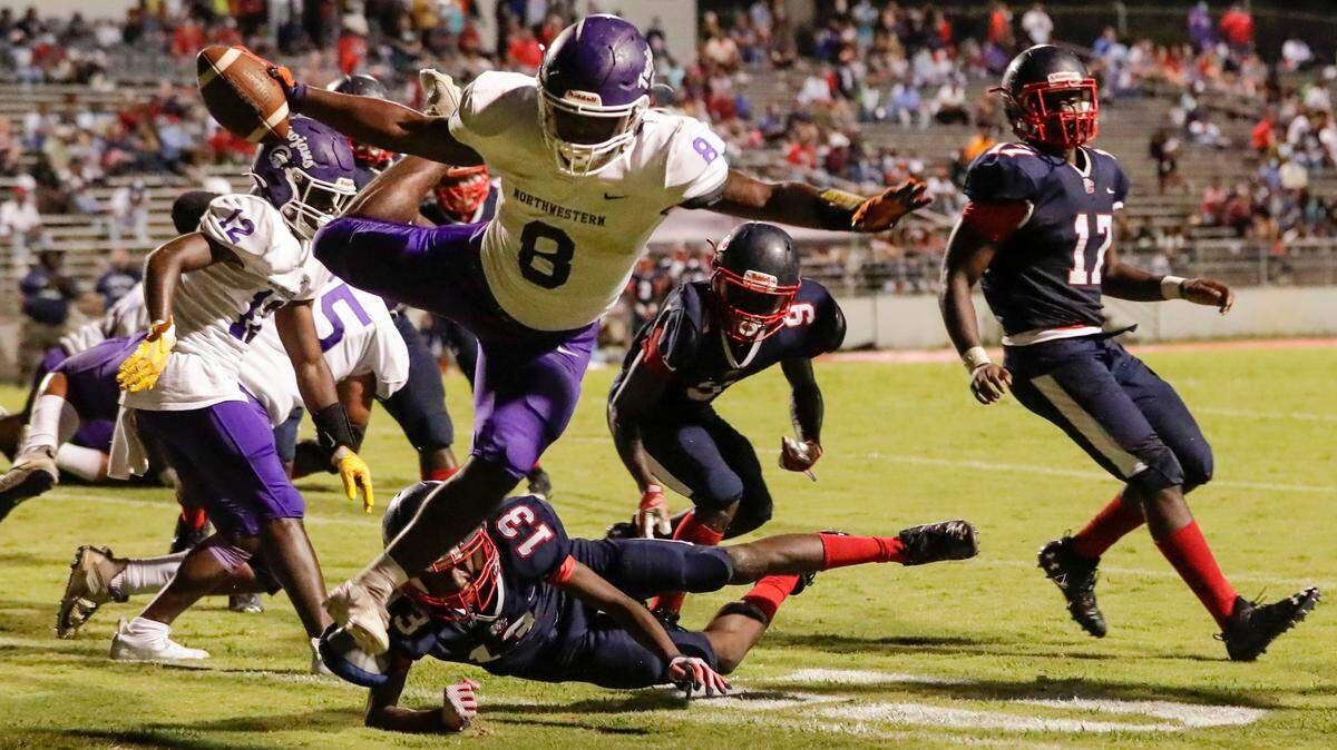 Northwestern’s (8) Qua Howard carries for a Trojan touchdown as Chester hosts Northwestern in Friday night football 9-10-2021.