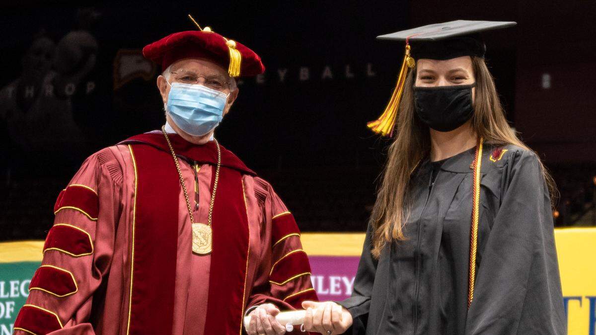 Winthrop interim president George Hynd (left) congratulates Scarlett Black (right) on receiving the President’s Award.
