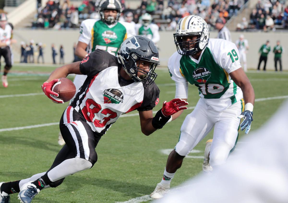 South Carolina’s Jaylin Lane (83) of Clover High School, heads to the endzone against North Carolina’s Ja’Qurious Conley of Northside Jacksonville High School Saturday at the Shrine Bowl in Spartanburg.