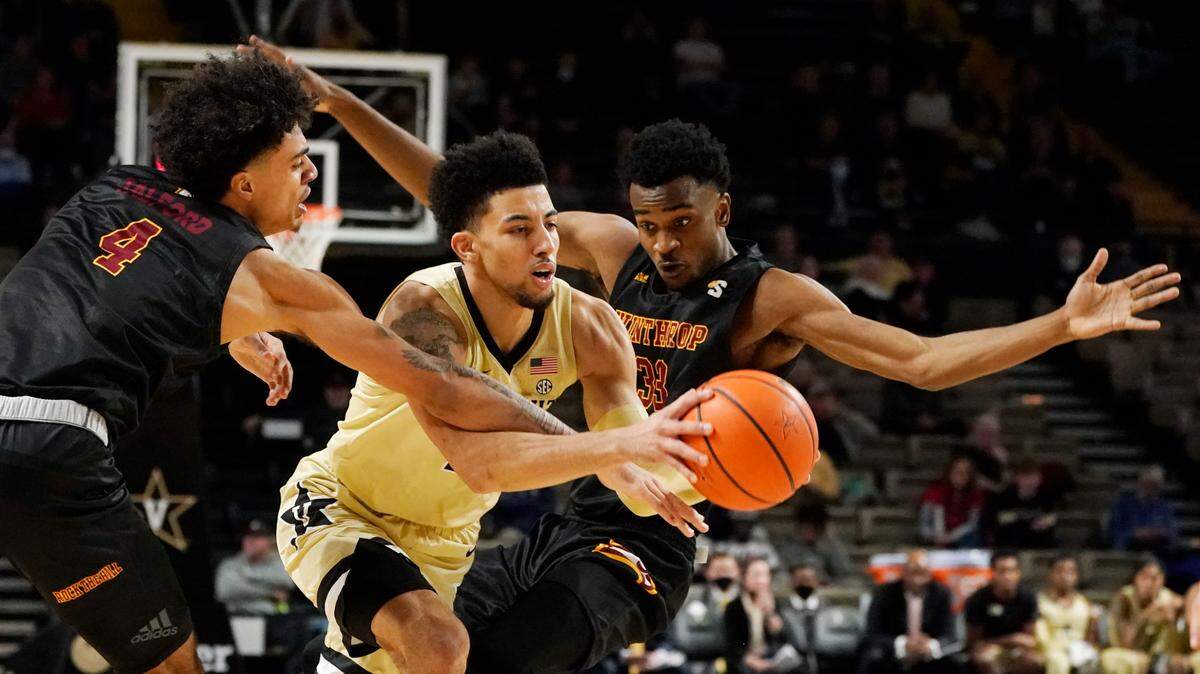 Vanderbilt guard Scotty Pippen Jr., center, drives between Winthrop’s Kelton Talford (4) and Chase Claxton, right, in the first half of an NCAA college basketball game Saturday, Nov. 20, 2021, in Nashville, Tenn. (AP Photo/Mark Humphrey)
