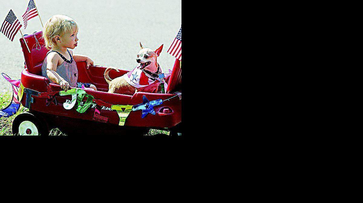 Emily Alexander,18 months, waits in her wagon with the family dog, Max, on Wednesday for the Country Club Estates' 53rd annual Fourth of July parade to begin.

Participants in the Tega Cay boat parade Wednesday morning on Lake Wylie celebrate the 25th anniversary of Tega Cay as a city. The parade was just part of the celebrations that took place around the area.