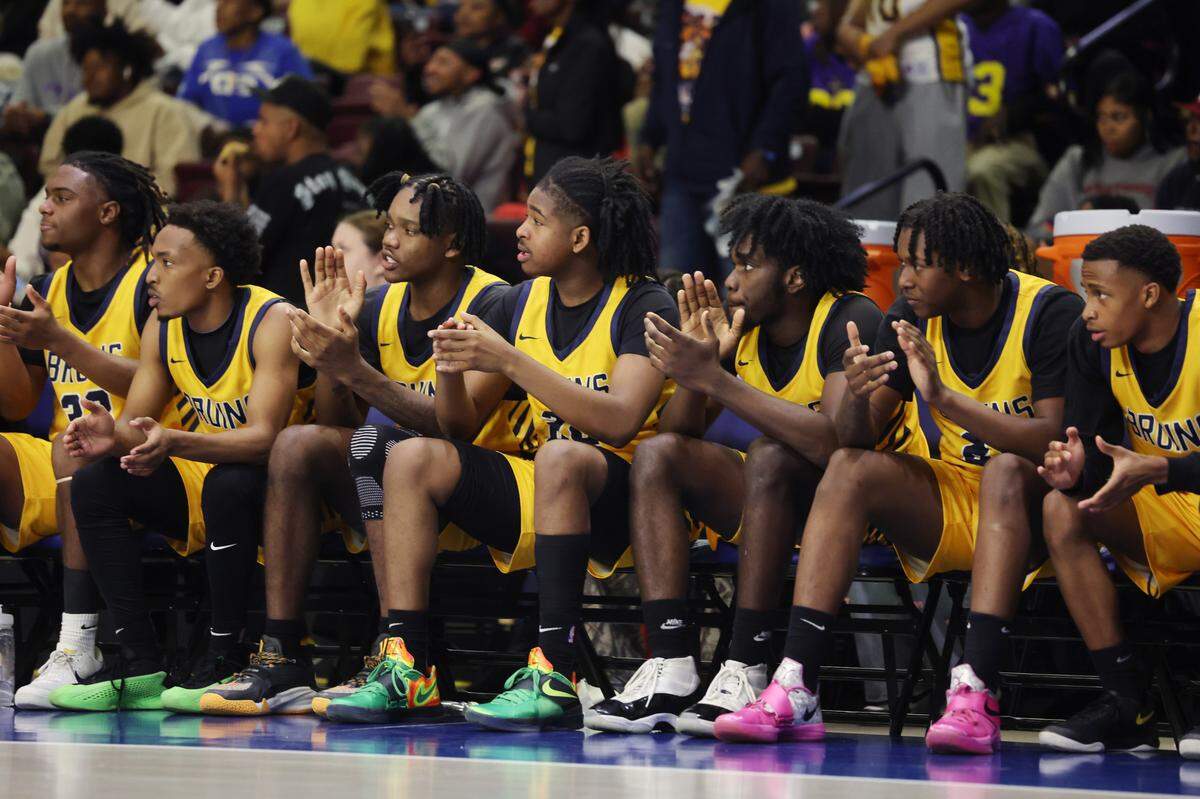 The Lancaster High Schools boys varsity basketball team claps during the Class 4A state championship game in Florence Friday.