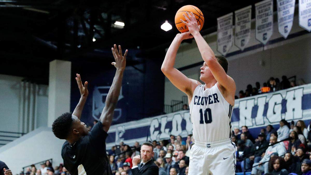 Clover’s #10 Markus Nastase puts up a 3 pointer over York’s #4 Zy Brown as the Blue Eagles defeat the Cougars 67-48 in Friday night varsity basketball, 12-13-2019.