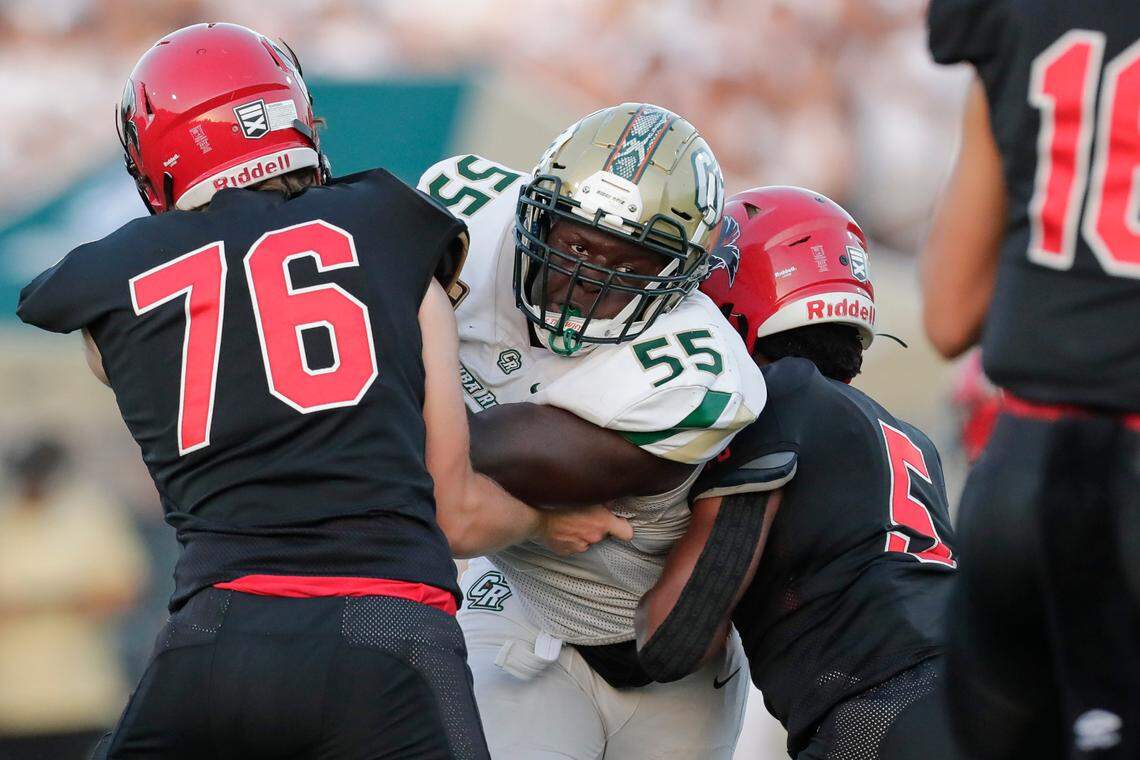 Nation Ford’s (76) TJ Miller holds his ground as Catawba Ridge’s (55) Asa Johnson pressures his way to the quarterback as Nation Ford hosts Catawba Ridge in a Friday night cross town football rivalry, 8-27-2021.