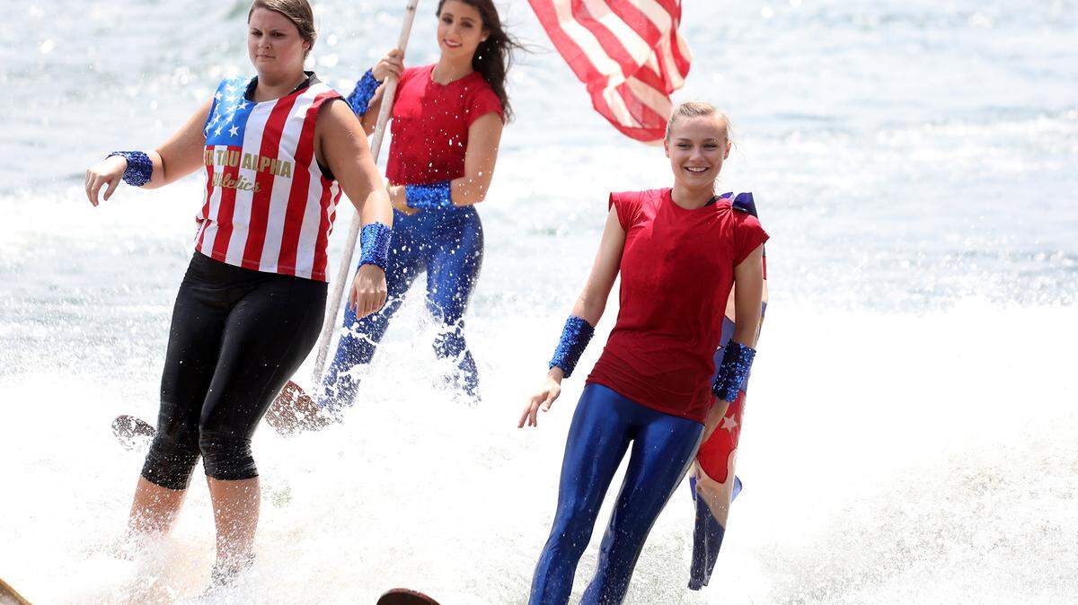 Skiers with the Carolina Show Ski Team ride a wave into Winjammer Park ahead of Tega Cay’s 4th of July boat parade.