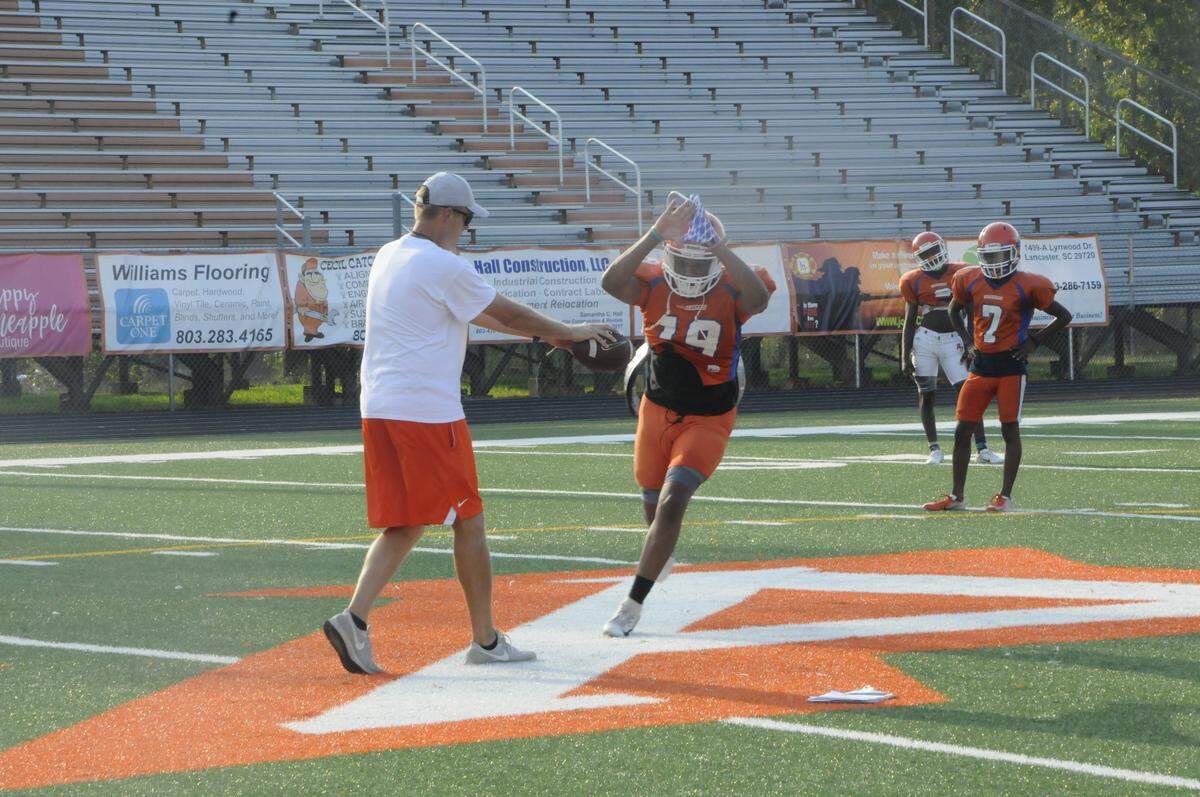 Andrew Jackson head football coach Todd Shigley leads his players through a drill in blocking punts on a practice in September 2019.