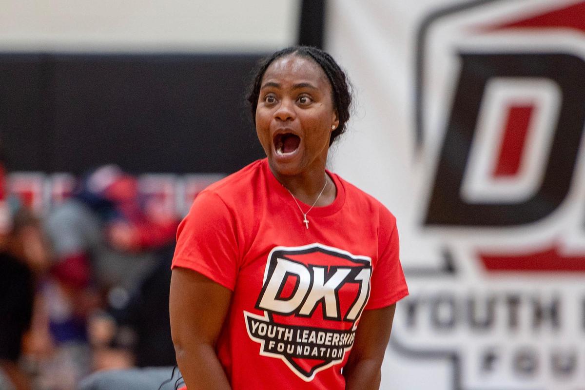 Ivory Latta, former WNBA player and South Carolina native, reacts to campers playing basketball during Derion Kendrick’s two-day youth football camp at South Pointe High School in Rock Hill.