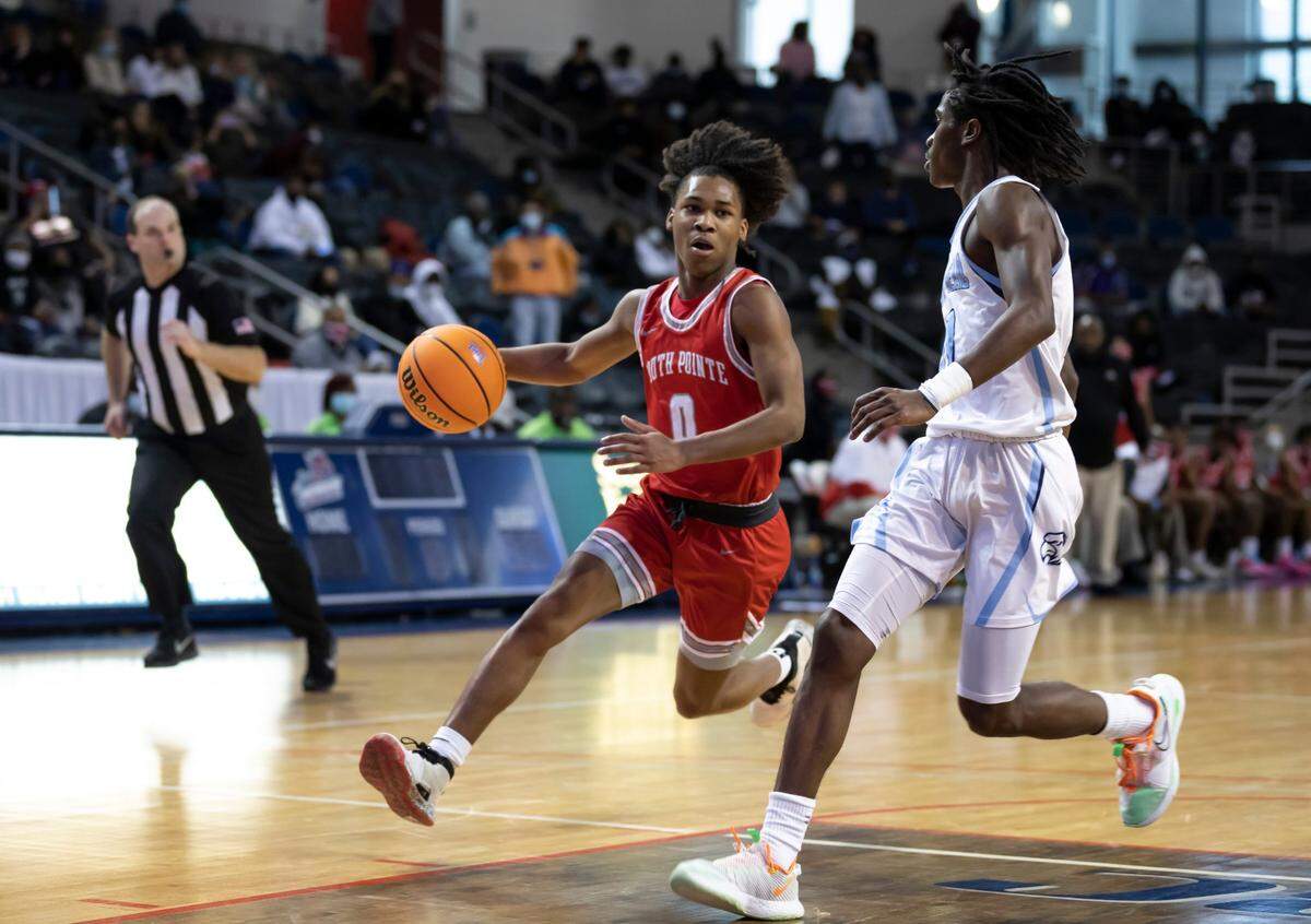 Chris McCullough (left) of South Pointe High School brings the ball up the court as Alex Smith of Hilton Head High School looks on during the SCHSL Class AAAA state final game held Saturday, March 6, 2021 at the USC Aiken Convocation Center.