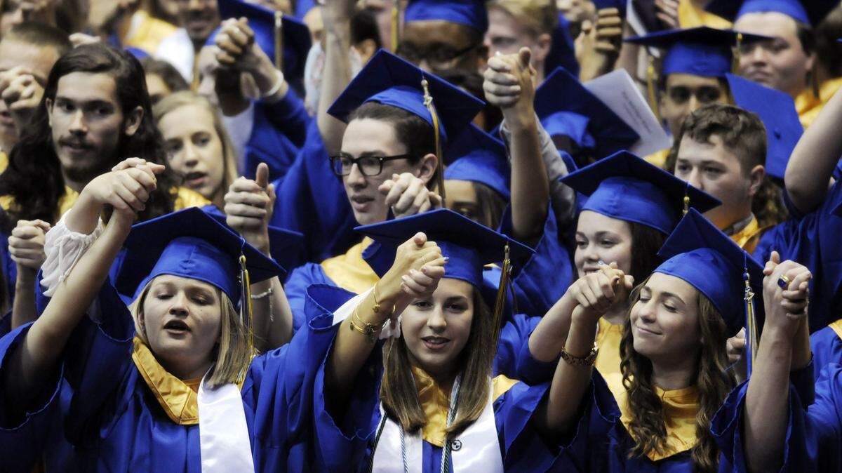 Fort Mill High School graduates sing the alma mater during the 2017 commencement at the Winthrop University Coliseum. This year’s ceremonies kick off June 7.