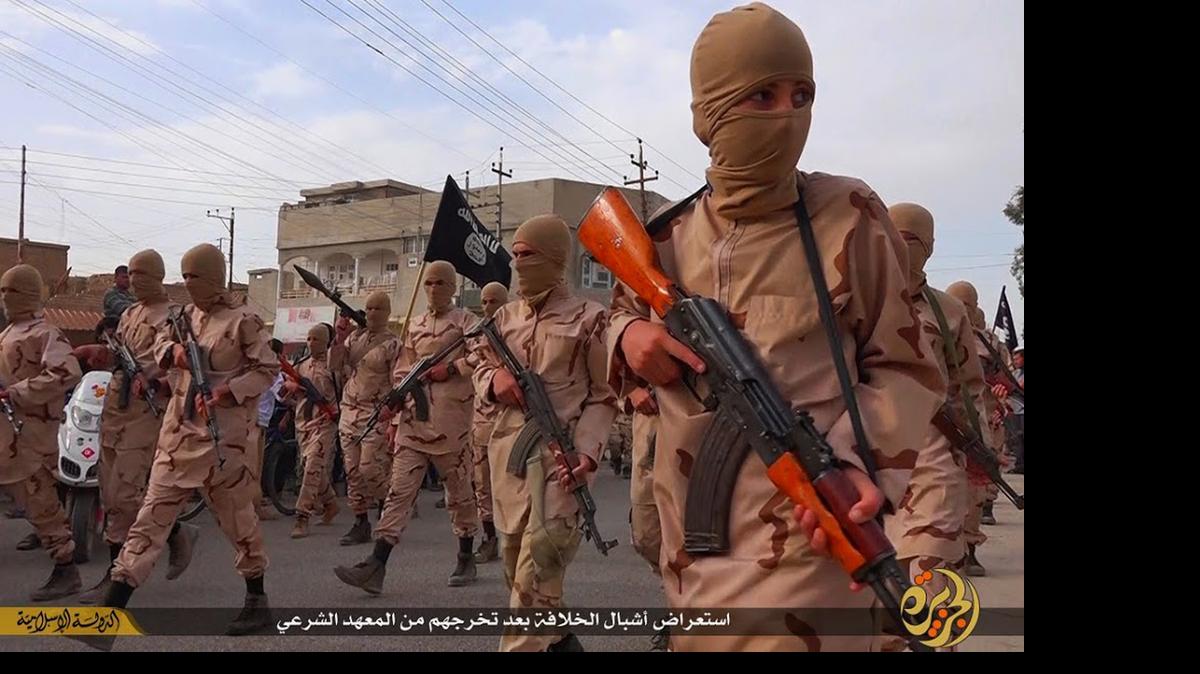 
In this photo released on April 25, 2015 by a militant website, which has been verified and is consistent with other AP reporting, young boys known as the "lion cubs" hold rifles during a parade after graduating from a religious school in Tal Afar, near Mosul, northern Iraq. The Syrian Observatory for Human Rights, a Britain-based organization that follows the Syrian war, said it documented at least 1,100 Syrian children under 16 who joined IS so far this year, many of whom were then sent to fight in Syria and Iraq. (Militant website via AP)
