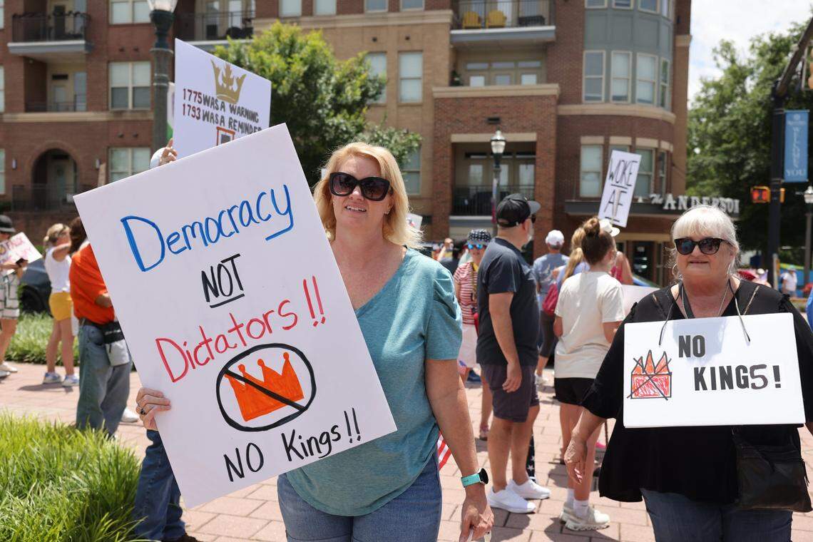 Protesters walk with signs in downtown Rock Hill before the ‘No Kings’ protest against President Trump Saturday, June 14, 2025 in Rock Hill, S.C.