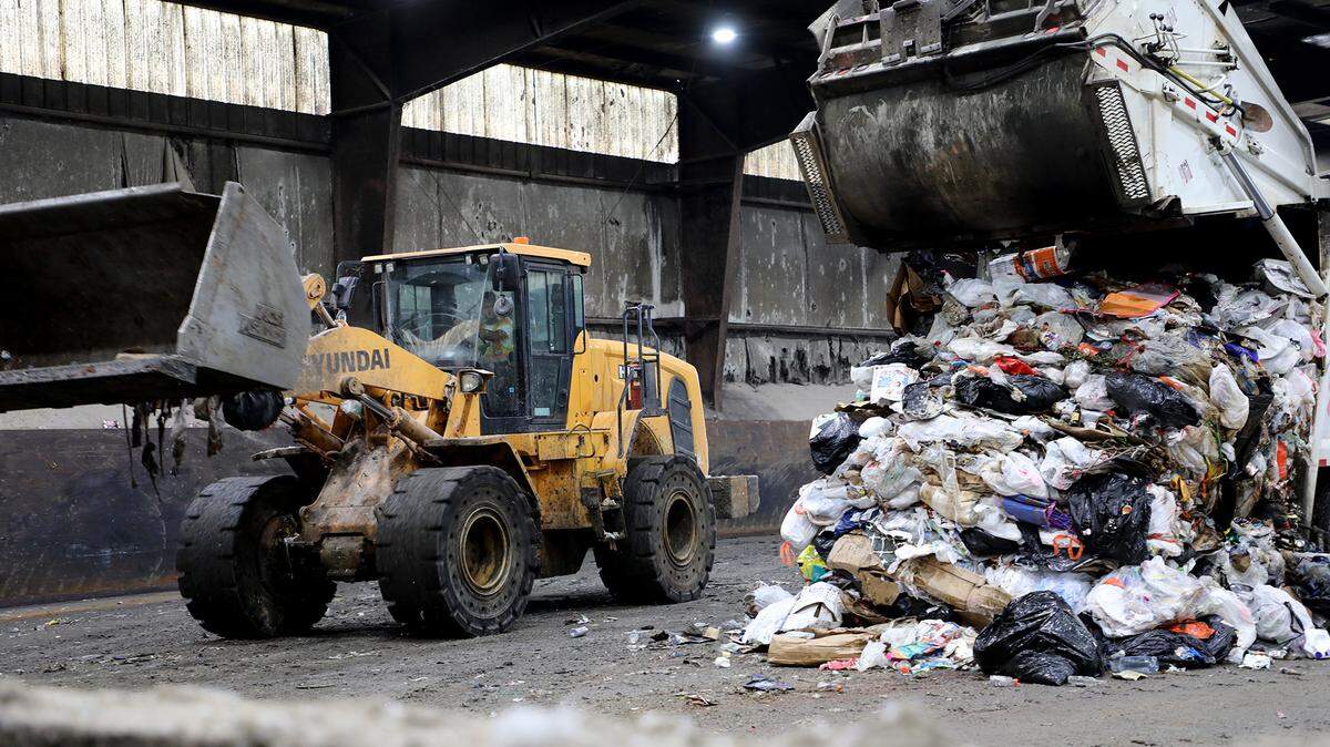 A worker prepares to move trash at the York County landfill Thursday in York.