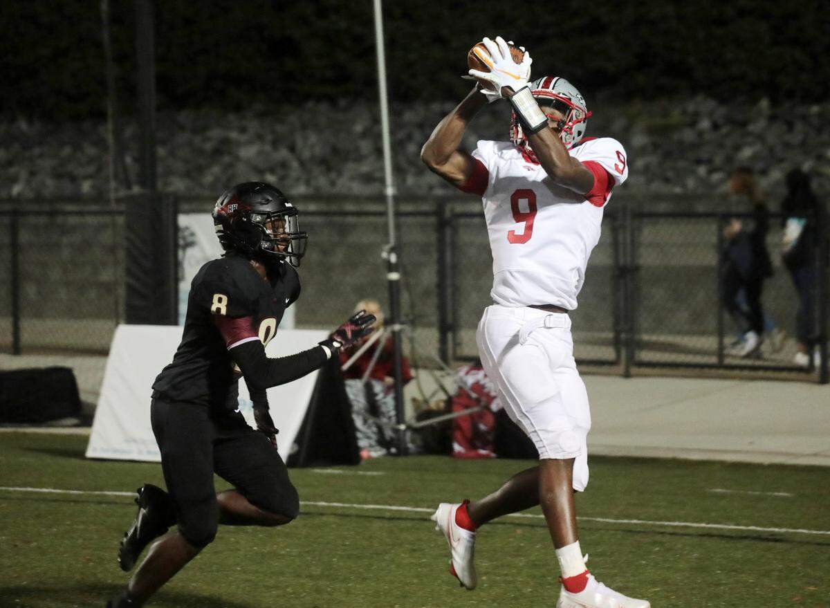 South Pointe’s O’mega Blake makes a touchdown ahead of Rock Hill’s Buck Peay Friday as the Bearcats and Stallions meet at District Three Stadium.