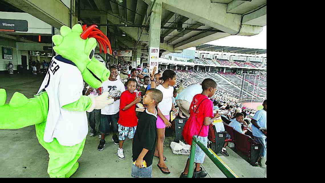 The Charlotte Knights mascot, Homer the Dragon, greets young fans at Knights Stadium in Fort Mill.