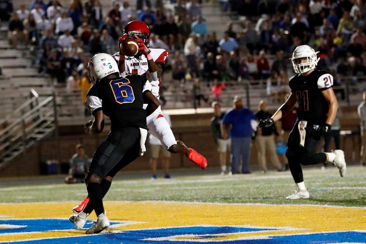 Fort Mill’s Mack Gadsen (6) breaks up a touchdown pass to Nation Ford’s Jerrick Foster (4) as Fort Mill hosts Nation Ford in a cross town football rivalry Friday.