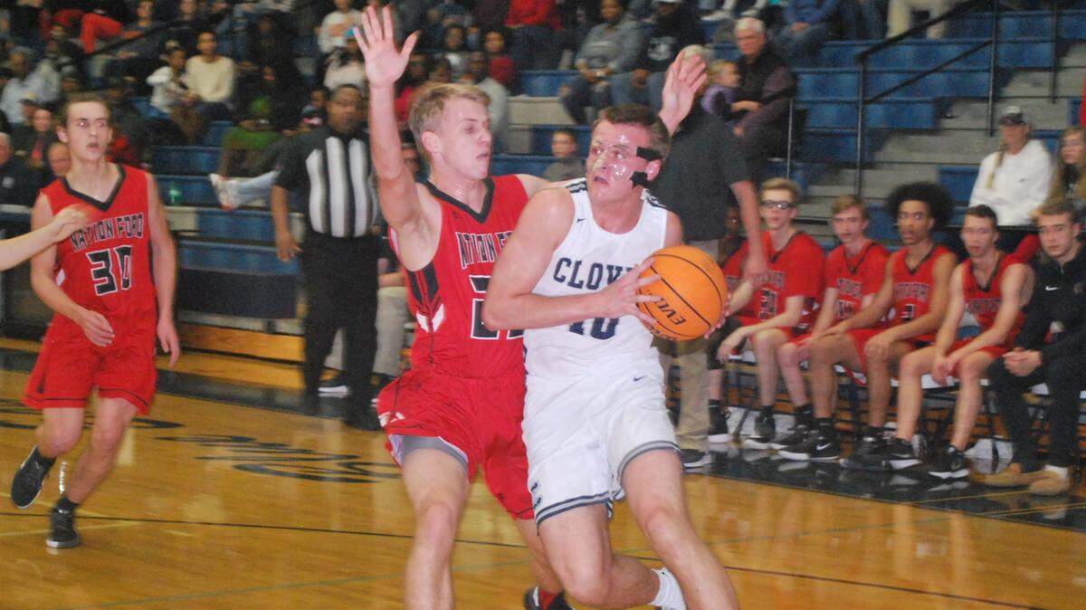 Clover’s Markus Nastase drives by Nation Ford’s Andrew Meacham during the Blue Eagles’ game against Nation Ford on Tuesday, Feb. 4, 2020.