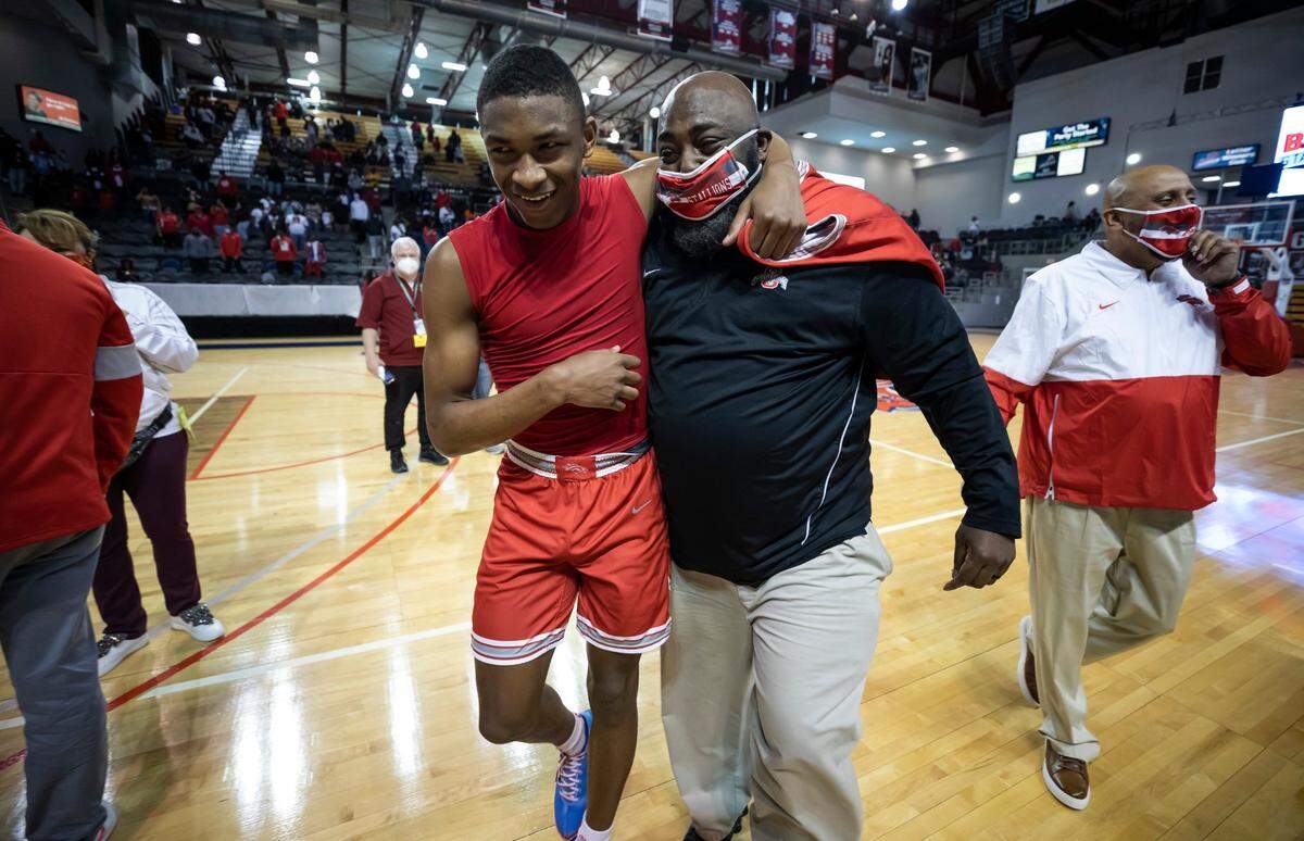 Coach Melvin Watson gets a hug from Waymond Jenerette following South Pointe High School’s 52-50 win over Hilton Head in the SCHSL Class AAAA state final game held Saturday, March 6, 2021 at the USC Aiken Convocation Center.