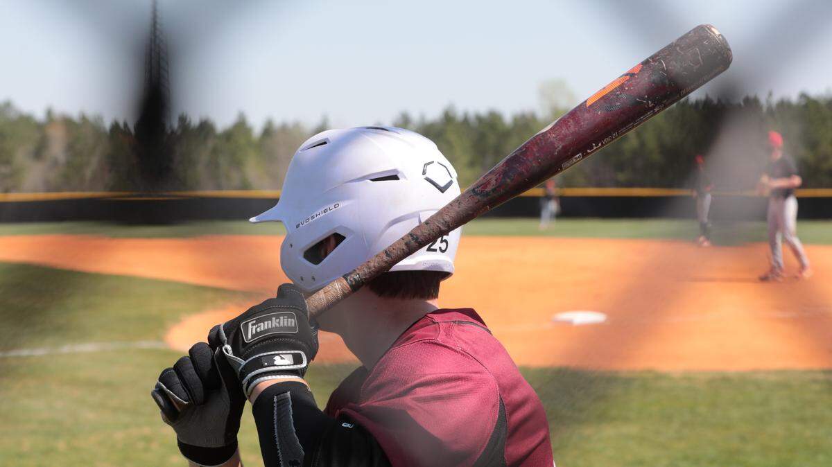 A Rock Hill High School baseball player warms up Tuesday as the Bearcats and South Pointe Stallions compete.