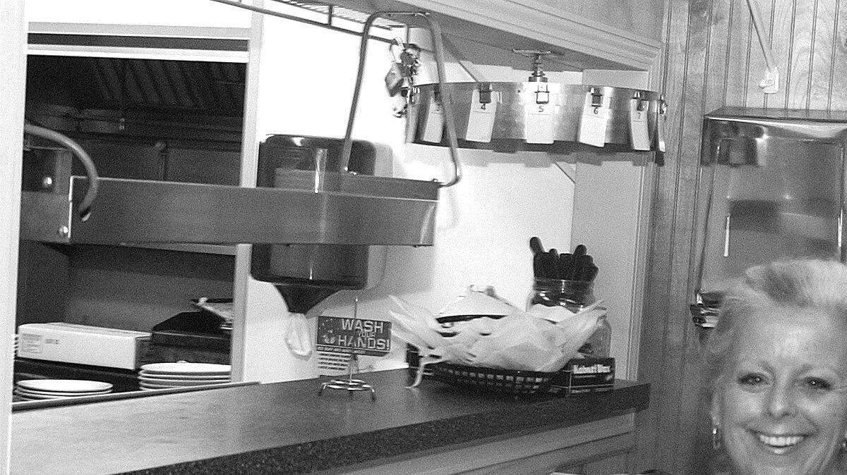 Tammy McDonald picks up an oder from the kitchen at Clover Family Restaurant.