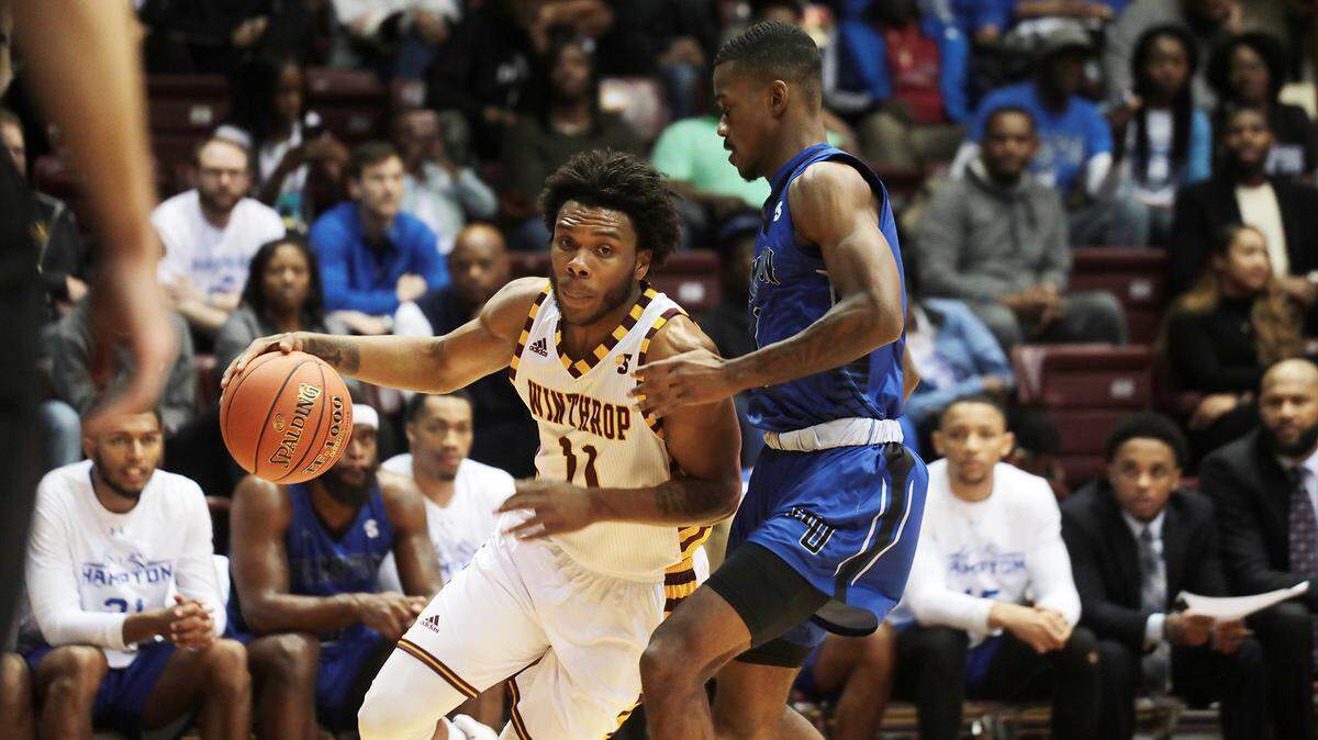 Winthrop’s Charles Falden drives past Hampton’s Lysander Bracey in a 2019 game. Falden has been huge to the Eagles’ success in 2020-21.