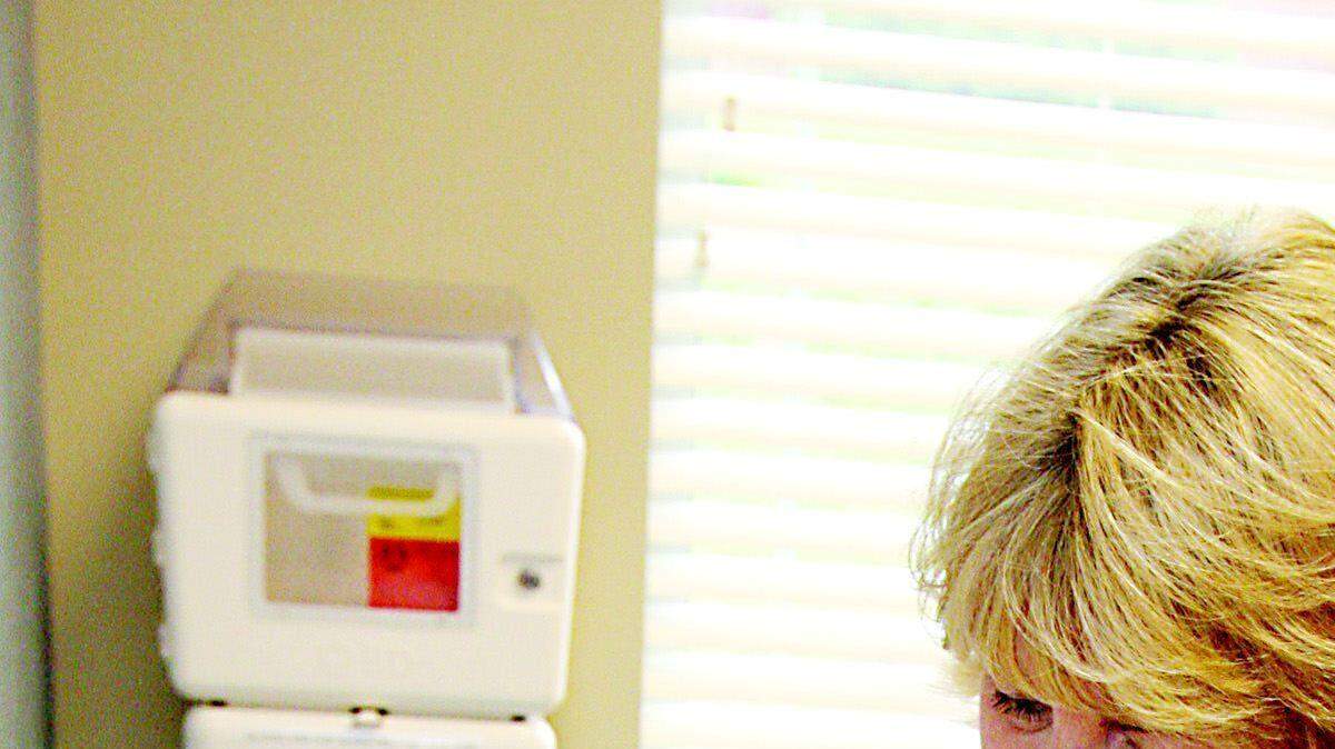 Jill Norris, right, holds her 4-month-old son, Ethan, as nurse Sheila Gonzales gives him vaccinations at the office of Rock Hill pediatrician Dr. Hal Copple on Wednesday.