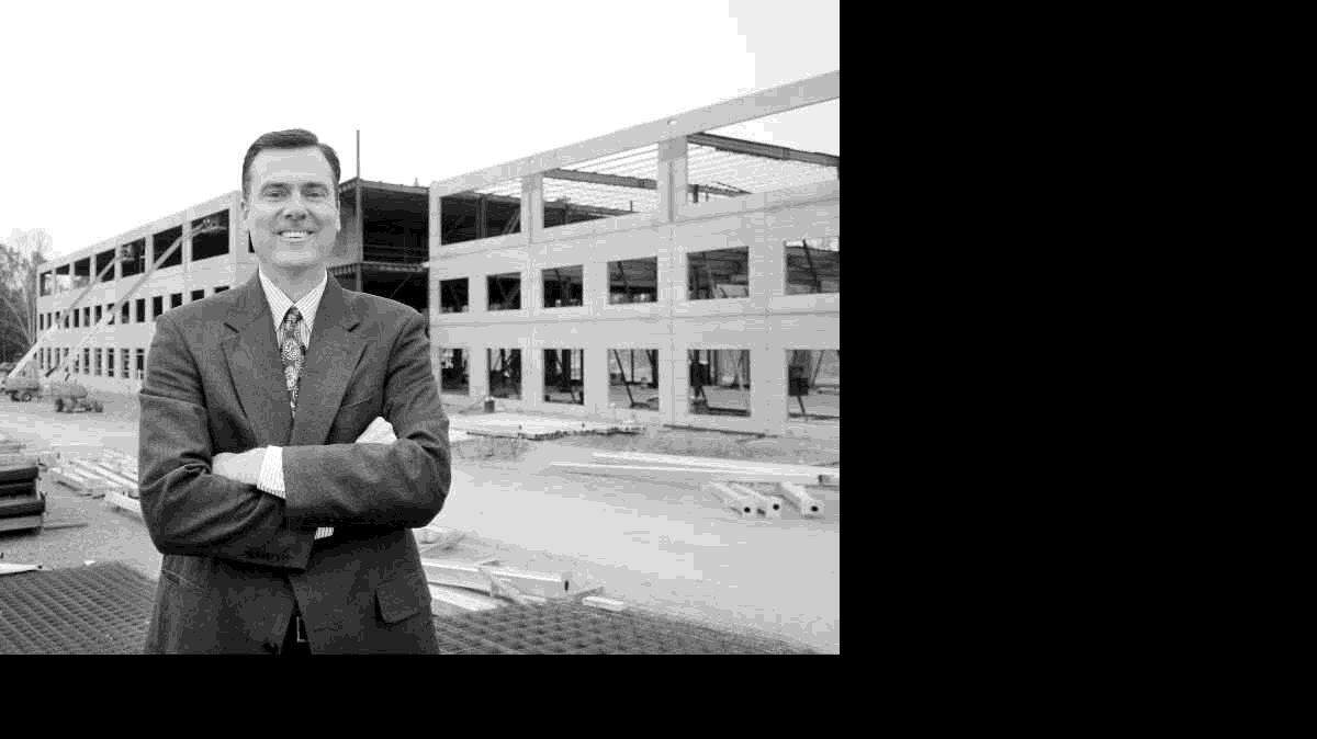 Mark Farris, York County's economic development director, stands in front of the Koll Intelli Center, a 168,000-square-foot office building under construction near Knights Stadium in Fort Mill.