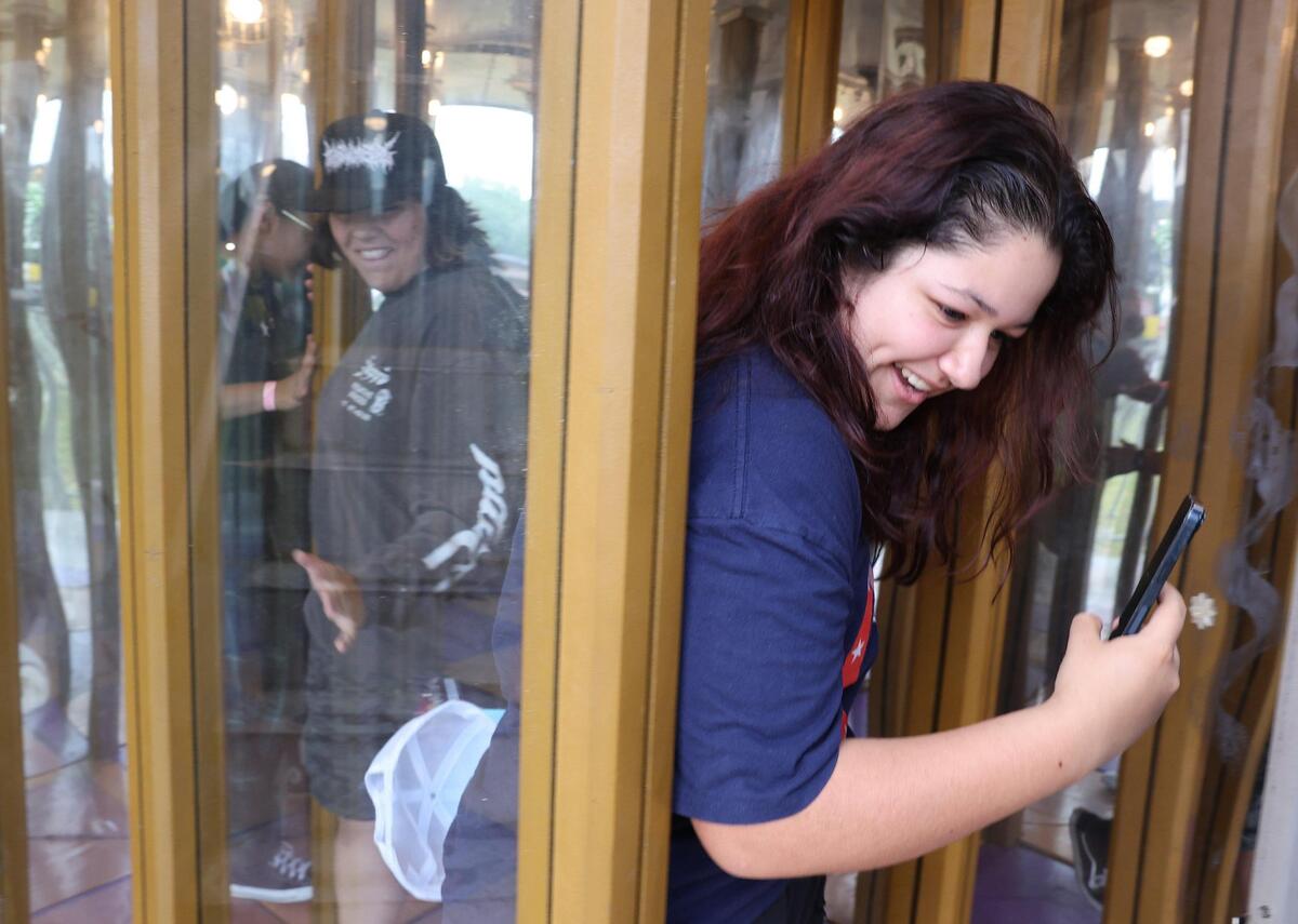 Madison Ceja works her way out of a house of mirrors Friday, May 2, 2025 at the Strawberry Festival in Fort Mill.