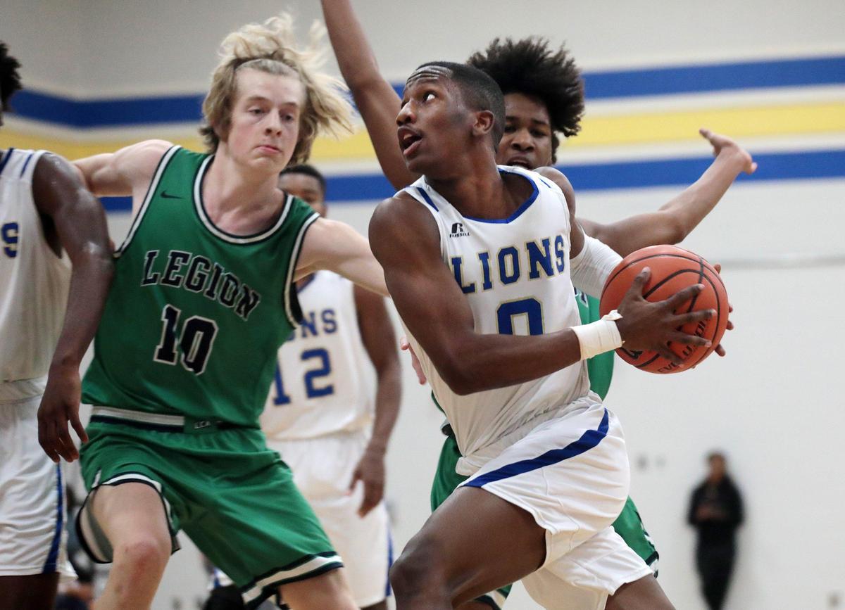 Lewisville’s Demetric Hardin heads to the basket as Legion Collegiate’s Isaac Hawkins tries to block him in a game in the 2019-20 season. The Lancers and the Lions competed in varsity basketball in Richburg, S.C.