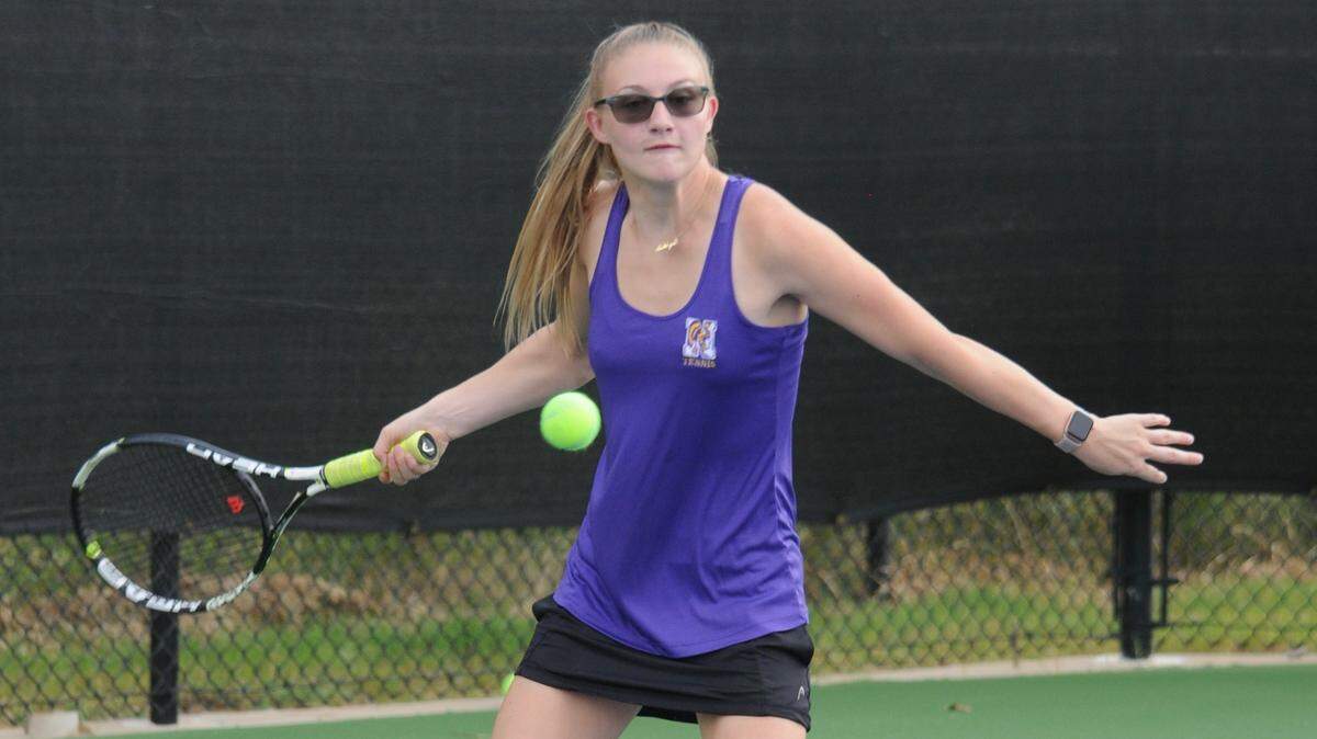 Ashlyn Glover hits a forehand before a match in her senior season. By Thursday, Oct. 3, Glover remains unbeaten in region play.