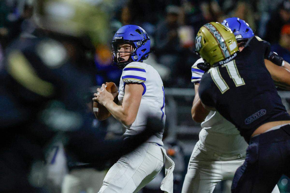 Indian Land quarterback Matt Kucia (1) looks down field as the undefeated Warriors take on Catawba Ridge earlier this month.
