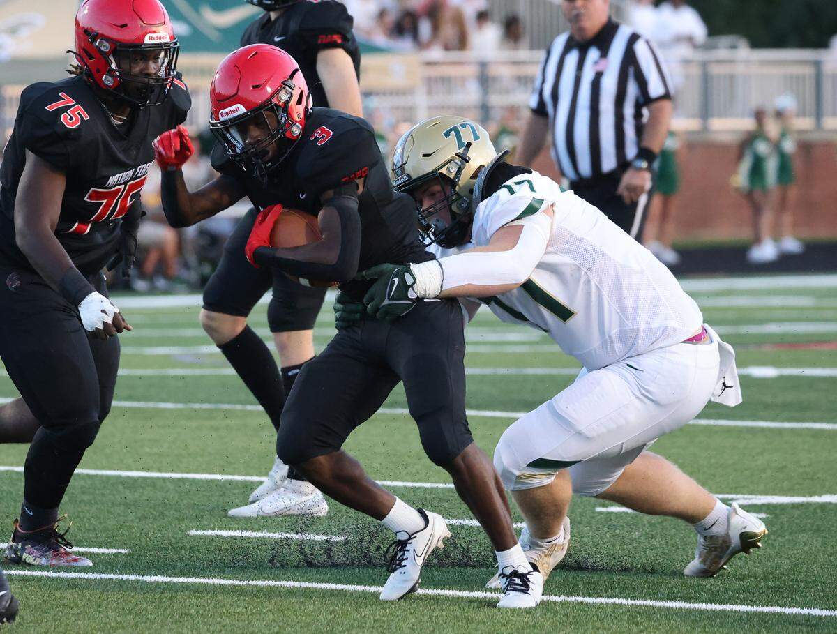 Catawba Ridge’s Lewis Price (77) tries to bring down Nation Ford’s Kaleb White on Friday, Sept. 1, 2023.